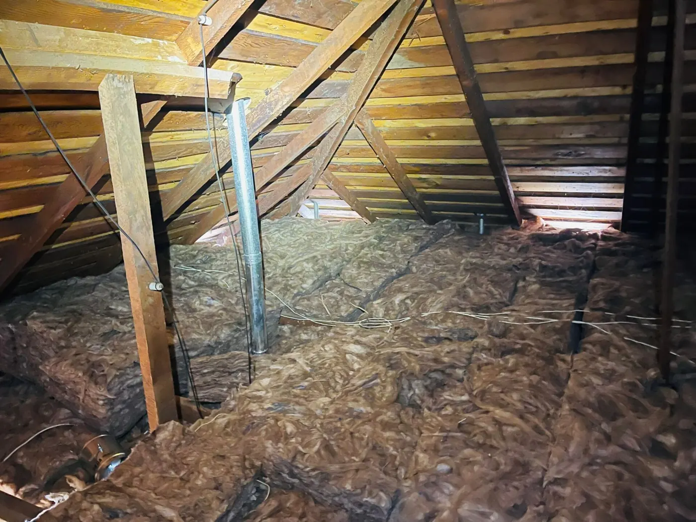 Attic with new insulation installed wall to wall