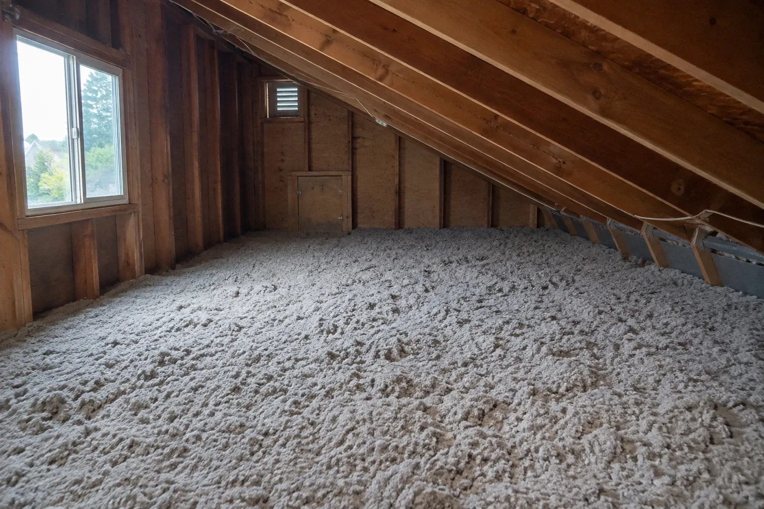 After: The completed attic insulation upgrade with fully dense blown cellulose insulation and proper ventilation baffles in place.