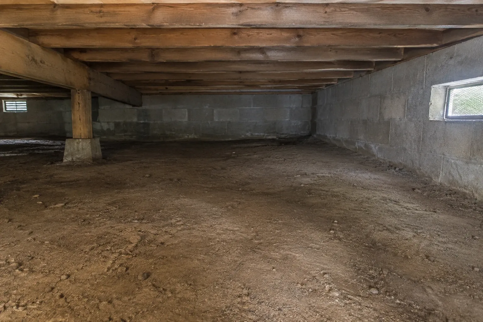 After: The crawl space is fully cleaned of all debris and old vapor barrier remnants, leaving a neat, ready-for-maintenance space.
