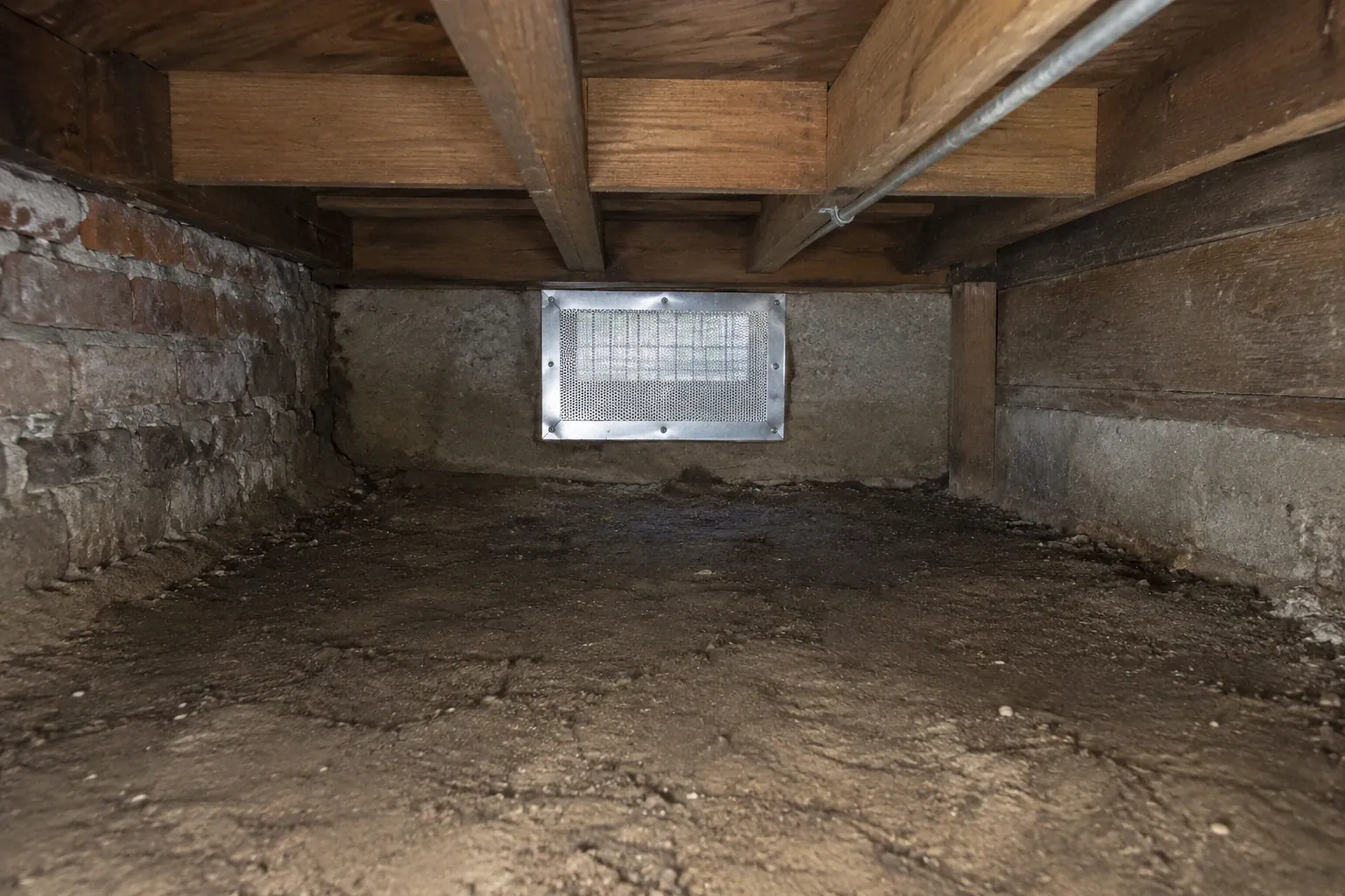 After: The crawl space vent is fully rodent-proofed with steel mesh and metal patching, and the area is cleaned and sealed against further infestation.