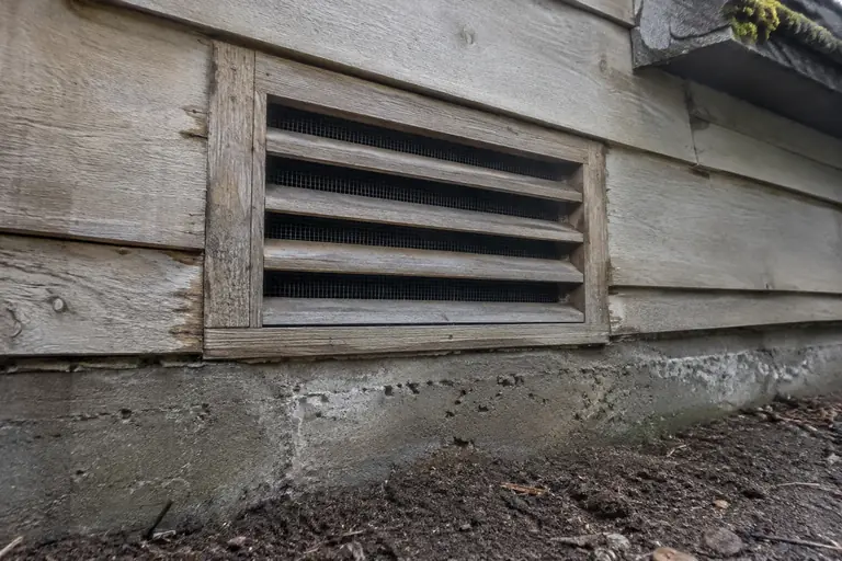 Foundation vent rebuild and screening, after: The foundation vent is now securely rebuilt and screened, preventing rodent entry.
