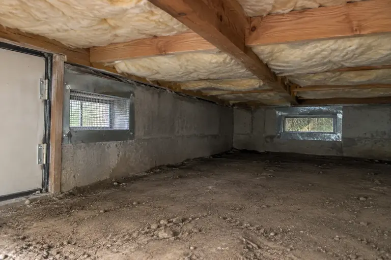 Rodent proofing a two-story home's crawl space, after: Clean, and free of damage, with all entry points sealed and insulation intact.