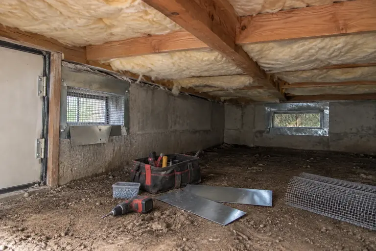 Rodent proofing a two-story home's crawl space, in progress: Inspection and removal of rodent nesting debris begins.